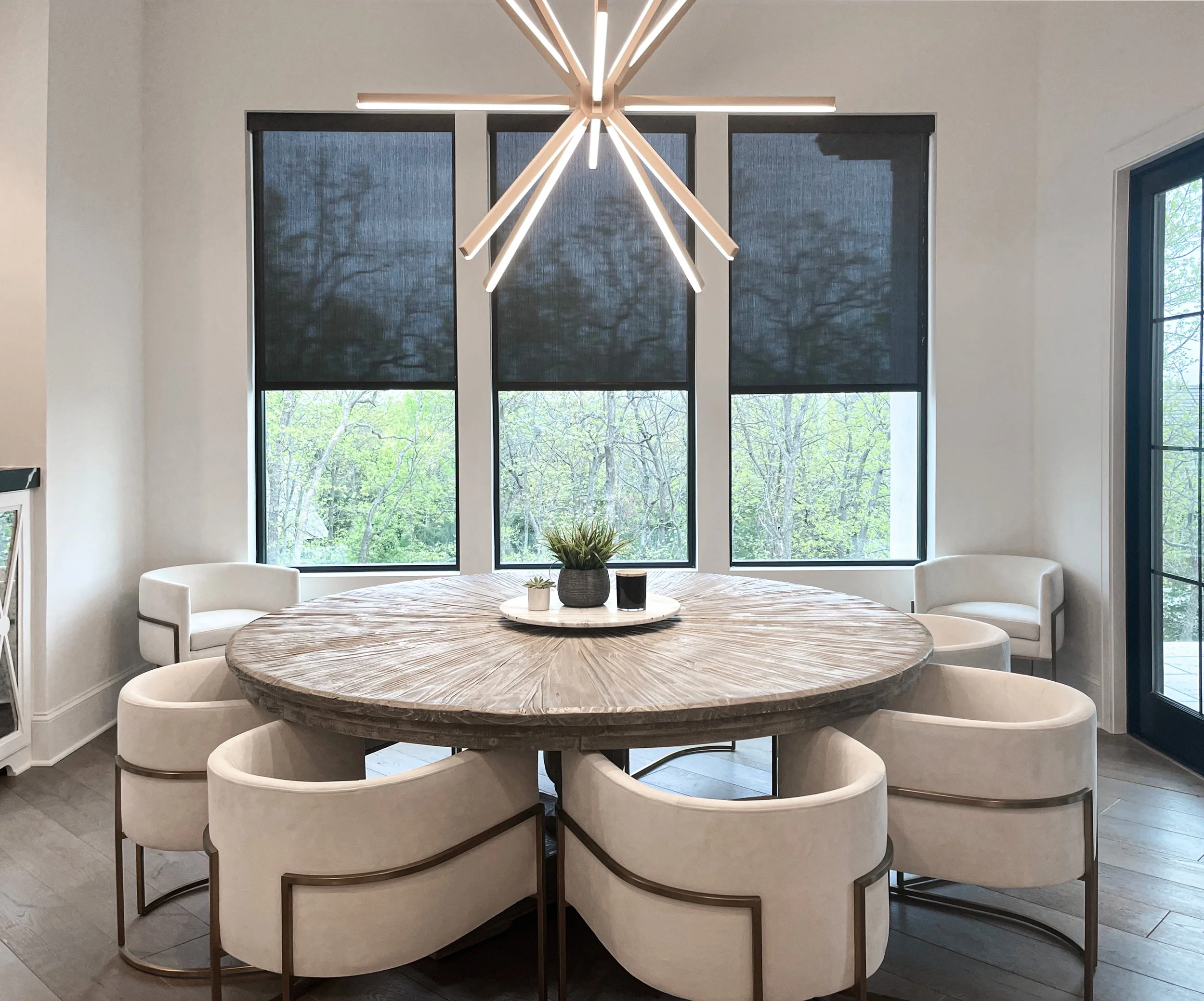 Modern dining room with motorized shades partially lowered