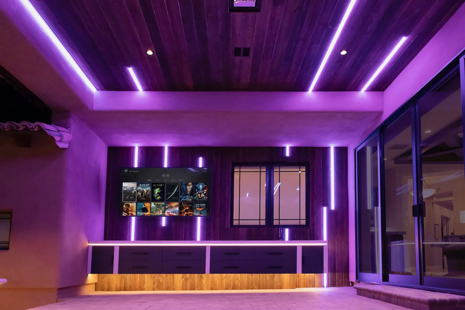 Media room with LED accent lighting and on-screen movie library